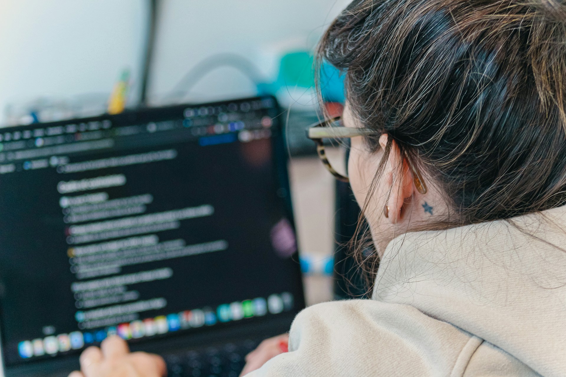 Person writing automation code on a laptop